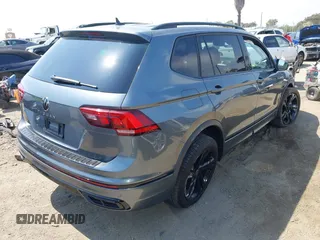 2023 Volkswagen Tiguan SE R-Line Black with VIN 3VVCB7AX8PM036684, listed as a IAAI auction lot 42169004 with 25,024 mi miles and . Bid and sale history available at DreamBid. Image 4.