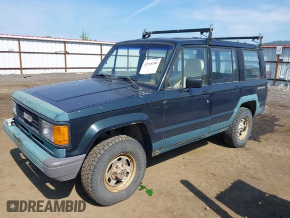 1990 Isuzu Trooper z VIN JACCH58EXL7903060, wystawiony jako IAAI lot #42516100 z przebiegiem 189 700 mil mil oraz . Historia ofert i sprzedaży dostępna na DreamBid. Obrazek 2.