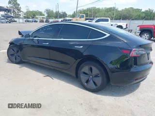 2020 Tesla Model 3 Standard Range Plus z VIN 5YJ3E1EA9LF738102, wystawiony jako IAAI lot #42107744 z przebiegiem 73 294 mil mil oraz . Historia ofert i sprzedaży dostępna na DreamBid. Obrazek 3.