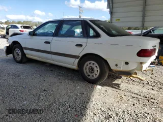 1992 Ford Taurus GL z VIN 1FALP52U5NA280821, wystawiony jako Copart lot #77457304 z przebiegiem 33 484 mil mil oraz Szkoda całkowita • Salvage title. Historia ofert i sprzedaży dostępna na DreamBid. Obrazek 2.