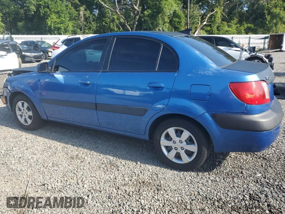 2009 Kia Rio LX with VIN KNADE223296515613, listed as a Copart auction lot 62008194 with 143,238 mi miles and Salvage Title. Bid and sale history available at carsss.com. Image 2.
