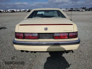 1992 Cadillac Seville z VIN 1G6KS53B0NU837105, wystawiony jako Copart lot #55865205 z przebiegiem 94 740 mil mil oraz Szkody całkowita. Historia ofert i sprzedaży dostępna na DreamBid. Obrazek 6.
