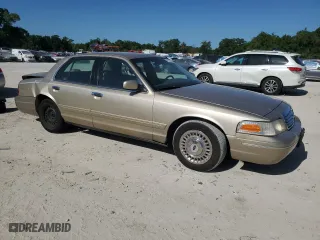 2000 Ford Crown Victoria with VIN 2FAFP73W4YX216080, listed as a Copart auction lot 53774835 with 144,404 mi miles and Salvage Title. Bid and sale history available at carsss.com. Image 4.