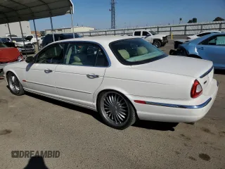 2005 Jaguar XJ with VIN SAJWA79C35SG48607, listed as a Copart auction lot 77132444 with 159,051 mi miles and Salvage Title. Bid and sale history available at carsss.com. Image 2.