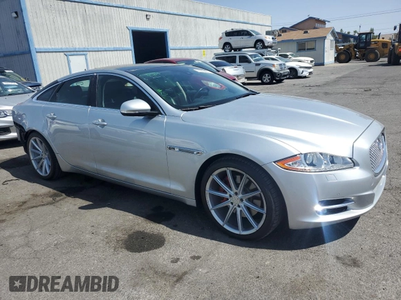 2015 Jaguar XJ with VIN SAJWJ1CD4F8V82496, listed as a Copart auction lot 71013474 with 52,744 mi miles and Salvage title. Bid and sale history available at DreamBid. Image 4.