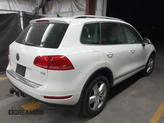 2012 Volkswagen Touareg Sport with VIN WVGFK9BP2CD002991, listed as a IAAI auction lot 42077523 with 94,515 mi miles and . Bid and sale history available at DreamBid. Image 4.