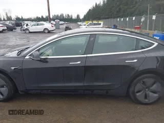 2019 Tesla Model 3 Mid Range with VIN 5YJ3E1EAXKF296378, listed as a IAAI auction lot 41739616 with 77,100 mi miles and . Bid and sale history available at DreamBid. Image 13.