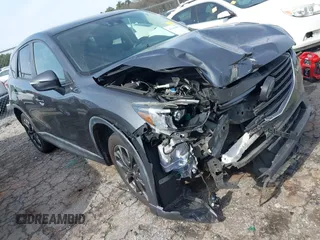 2016 Mazda CX-5 Grand Touring z VIN JM3KE4DY5G0836891, wystawiony jako IAAI lot #41441065 z przebiegiem 120 808 mil mil oraz . Historia ofert i sprzedaży dostępna na DreamBid. Obrazek 1.