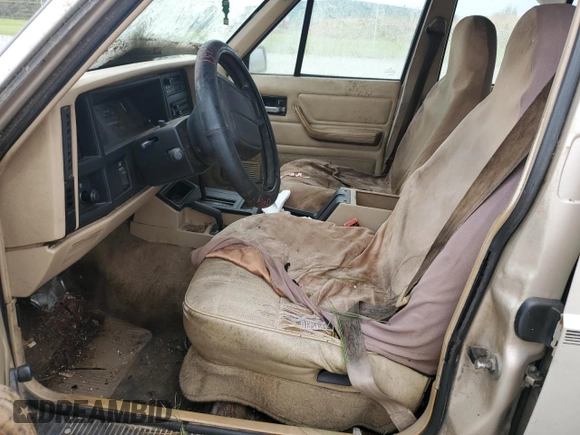 1995 Jeep Cherokee Sport with VIN 1J4FJ68S4SL618773, listed as a Copart auction lot 74126954 with 318,519 mi miles and Salvage title. Bid and sale history available at DreamBid. Image 7.
