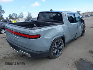 2023 Rivian R1T Adventure z VIN 7FCTGBAA9PN027894, wystawiony jako IAAI lot #42061339 z przebiegiem 5047 mil mil oraz . Historia ofert i sprzedaży dostępna na DreamBid. Obrazek 4.