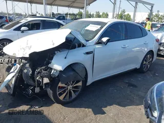2016 Kia Optima SX Turbo with VIN 5XXGW4L2XGG043934, listed as a IAAI auction lot 40451940 with 86,386 mi miles and . Bid and sale history available at carsss.com. Image 2.