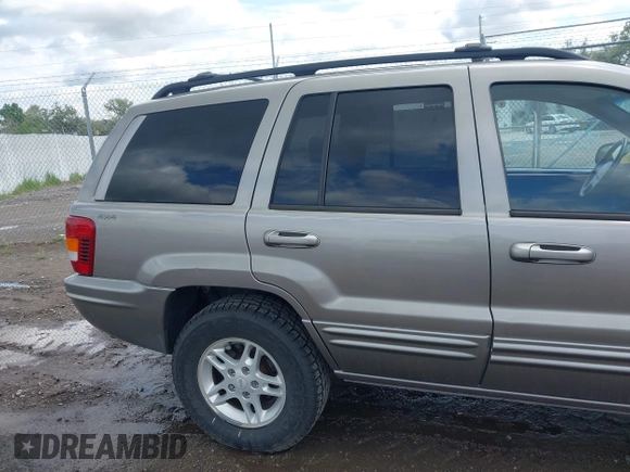 1999 Jeep Grand Cherokee Limited z VIN 1J4GW68N3XC597468, wystawiony jako IAAI lot #42353732 z przebiegiem 201 388 mil mil oraz . Historia ofert i sprzedaży dostępna na DreamBid. Obrazek 12.