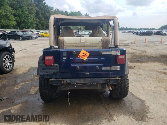 2000 Jeep Wrangler Sport with VIN 1J4FA49S0YP770943, listed as a Copart auction lot 68615524 with 165,377 mi miles and Salvage Title. Bid and sale history available at carsss.com. Image 6.