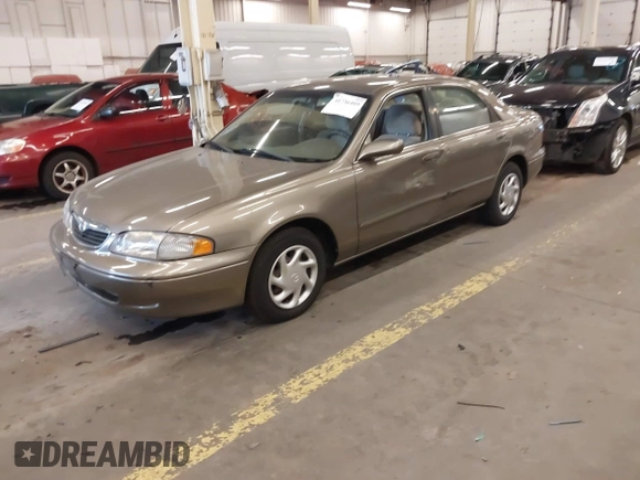 1999 Mazda 626 ES with VIN 1YVGF22C1X5852798, listed as a IAAI auction lot 41736489 with 136,536 mi miles. Bid and sale history available at carsss.com. Image 2.