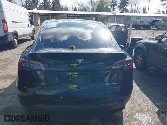 2022 Tesla Model Y Long Range with VIN 7SAYGDEEXNF459834, listed as a IAAI auction lot 42004576 with 56,175 mi miles and . Bid and sale history available at carsss.com. Image 16.