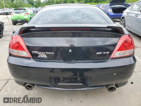 2006 Hyundai Tiburon GT z VIN KMHHN65F66U215304, wystawiony jako Copart lot #56141635 z przebiegiem 149 118 mil mil oraz Szkoda całkowita • Salvage title. Historia ofert i sprzedaży dostępna na DreamBid. Obrazek 6.
