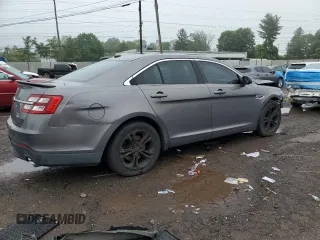 2013 Ford Taurus SEL z VIN 1FAHP2E87DG104349, wystawiony jako Copart lot #57143135 z przebiegiem 129 927 mil mil oraz Szkoda całkowita • Salvage title. Historia ofert i sprzedaży dostępna na DreamBid. Obrazek 3.