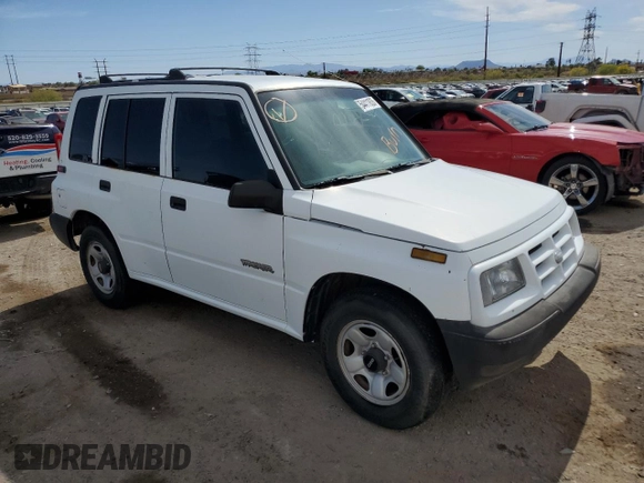 1996 Geo Tracker z VIN 2CNBE1364T6909947, wystawiony jako Copart lot #54411835 z przebiegiem 171 862 mil mil oraz Szkoda całkowita • Salvage title. Historia ofert i sprzedaży dostępna na DreamBid. Obrazek 4.