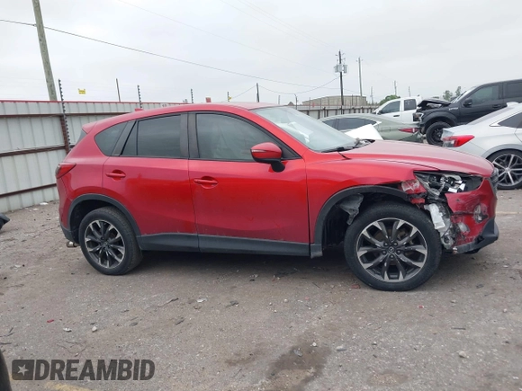 2016 Mazda CX-5 Grand Touring with VIN JM3KE2DY8G0871574, listed as a IAAI auction lot 41959686 with 95,416 mi miles and . Bid and sale history available at DreamBid. Image 13.