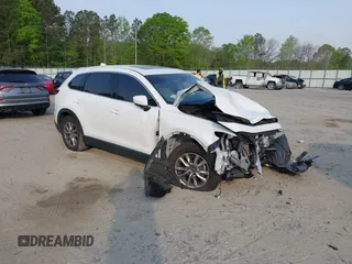 2018 Mazda CX-9 Touring z VIN JM3TCACY4J0219922, wystawiony jako IAAI lot #42040742 z przebiegiem 60 984 mil mil oraz . Historia ofert i sprzedaży dostępna na DreamBid. Obrazek 1.