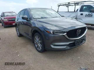 2021 Mazda CX-5 Grand Touring z VIN JM3KFBDM2M0431484, wystawiony jako IAAI lot #42547665 z przebiegiem 34 757 mil mil oraz . Historia ofert i sprzedaży dostępna na DreamBid. Obrazek 1.