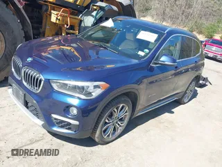 2017 BMW X1 xDrive28i with VIN WBXHT3C33H5F82035, listed as a IAAI auction lot 41944399 with 102,942 mi miles. Bid and sale history available at carsss.com. Image 2.