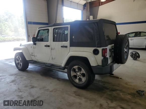 2016 Jeep Wrangler Unlimited Sahara with VIN 1C4BJWEGXGL310499, listed as a Copart auction lot 59756015 with 128,498 mi miles and Salvage title. Bid and sale history available at DreamBid. Image 2.