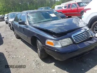2000 Ford Crown Victoria LX z VIN 2FAFP74W4YX116561, wystawiony jako IAAI lot #42101875 z przebiegiem Nie podano mil oraz . Historia ofert i sprzedaży dostępna na DreamBid. Obrazek 1.