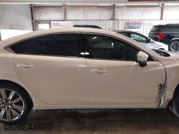 2021 Mazda 6 Carbon Edition with VIN JM1GL1WY9M1614117, listed as a IAAI auction lot 41305576 with 54,670 mi miles and . Bid and sale history available at DreamBid. Image 13.