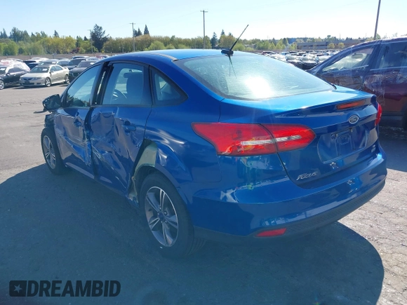 2018 Ford Focus SE z VIN 1FADP3FE4JL279265, wystawiony jako IAAI lot #42068130 z przebiegiem 43 616 mil mil oraz . Historia ofert i sprzedaży dostępna na DreamBid. Obrazek 3.
