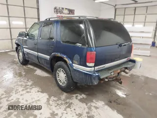 1999 GMC Jimmy SLE with VIN 1GKDT13W8X2534672, listed as a IAAI auction lot 41562434 with 240,145 mi miles. Bid and sale history available at carsss.com. Image 3.