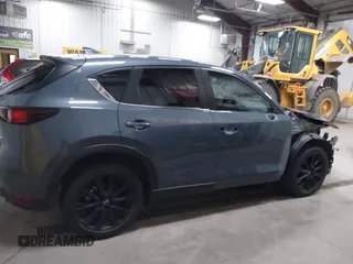 2021 Mazda CX-5 Touring z VIN JM3KFBCM4M0459465, wystawiony jako IAAI lot #41059836 z przebiegiem 74 645 mil mil oraz . Historia ofert i sprzedaży dostępna na DreamBid. Obrazek 14.