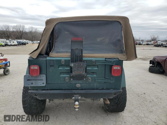 2000 Jeep Wrangler Sahara z VIN 1J4FA59S5YP803327, wystawiony jako Copart lot #44382505 z przebiegiem Nie podano mil oraz Szkoda całkowita • Salvage title. Historia ofert i sprzedaży dostępna na DreamBid. Obrazek 6.