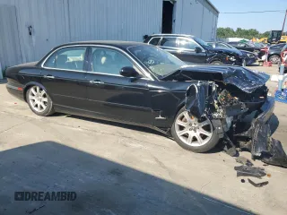 2004 Jaguar XJ with VIN SAJEA71C74SG02851, listed as a Copart auction lot 69056994 with 0 mi miles and Salvage Title. Bid and sale history available at carsss.com. Image 3.