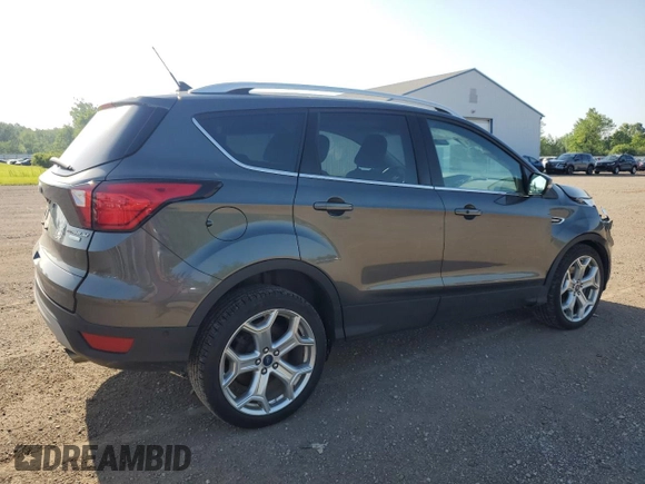2019 Ford Escape Titanium with VIN 1FMCU0J96KUB22884, listed as a Copart auction lot 61979665 with 63,824 mi miles and Salvage title. Bid and sale history available at DreamBid. Image 3.