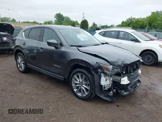2020 Mazda CX-5 Grand Touring with VIN JM3KFBDM9L1837738, listed as a IAAI auction lot 42356295 with 70,797 mi miles and . Bid and sale history available at DreamBid. Image 1.