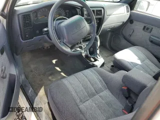 1999 Toyota Tacoma with VIN 4TAWN72N2XZ434256, listed as a Copart auction lot 49873685 with 285,424 mi miles and Salvage title. Bid and sale history available at DreamBid. Image 8.