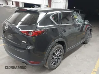 2018 Mazda CX-5 Grand Touring z VIN JM3KFADMXJ0311101, wystawiony jako IAAI lot #42163070 z przebiegiem 129 284 mil mil oraz . Historia ofert i sprzedaży dostępna na DreamBid. Obrazek 4.