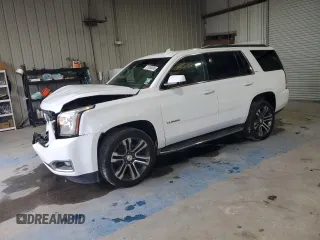 2016 GMC Yukon SLT with VIN 1GKS1BKC5GR450147, listed as a Copart auction lot 51058805 with 163,944 mi miles and Salvage Title. Bid and sale history available at carsss.com. Image 1.