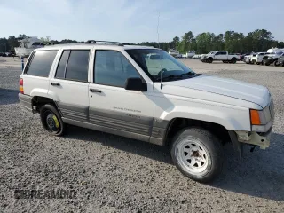 1996 Jeep Grand Cherokee Laredo z VIN 1J4EX58S3TC144191, wystawiony jako Copart lot #53153495 z przebiegiem 197 853 mil mil oraz Szkoda całkowita • Salvage title. Historia ofert i sprzedaży dostępna na DreamBid. Obrazek 4.