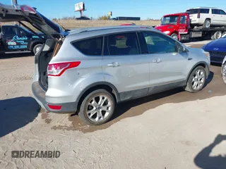 2014 Ford Escape Titanium with VIN 1FMCU0JX7EUC59643, listed as a IAAI auction lot 41082952 with 143,899 mi miles. Bid and sale history available at carsss.com. Image 4.