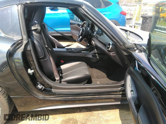 2021 Mazda MX-5 Miata Grand Touring z VIN JM1NDAM75M0451597, wystawiony jako IAAI lot #41932712 z przebiegiem 61 710 mil mil oraz . Historia ofert i sprzedaży dostępna na DreamBid. Obrazek 5.