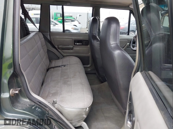 1996 Jeep Cherokee Sport z VIN 1J4FT68S6TL267408, wystawiony jako IAAI lot #42385629 z przebiegiem 268 753 mil mil oraz . Historia ofert i sprzedaży dostępna na DreamBid. Obrazek 8.