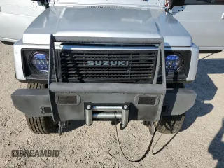 1987 Suzuki Samurai z VIN JS3JC51C3H4186141, wystawiony jako Copart lot #72551804 z przebiegiem 525 030 mil mil oraz Szkody całkowita. Historia ofert i sprzedaży dostępna na DreamBid. Obrazek 12.