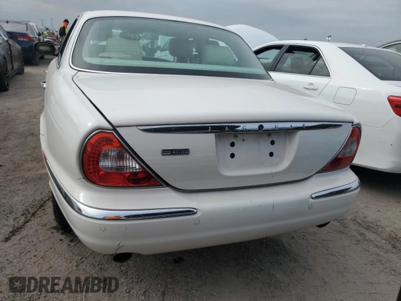 2004 Jaguar XJ with VIN SAJWA71C44SG34094, listed as a Copart auction lot 74969004 with 0 mi miles and Salvage Title. Bid and sale history available at carsss.com. Image 6.