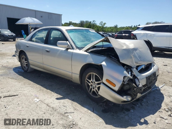 2000 Mazda Millenia with VIN JM1TA2210Y1614967, listed as a Copart auction lot 53606185 with 120,288 mi miles and Salvage Title. Bid and sale history available at DreamBid. Image 4.
