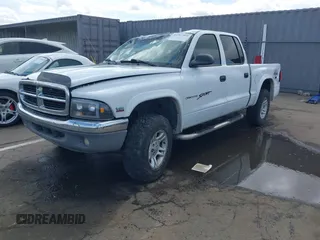 2004 Dodge Dakota SLT with VIN 1D7HG48N14S758614, listed as a IAAI auction lot 41907403 with 242,343 mi miles. Bid and sale history available at carsss.com. Image 2.