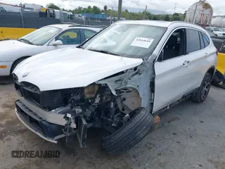 2018 BMW X1 sDrive28i with VIN WBXHU7C38J5L05985, listed as a IAAI auction lot 42014649 with 77,082 mi miles. Bid and sale history available at carsss.com. Image 2.