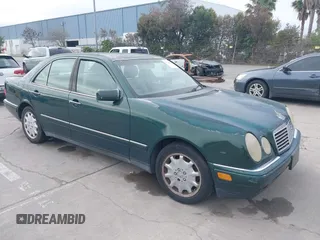 1997 Mercedes-Benz E-Class with VIN WDBJF55F3VJ034009, listed as a IAAI auction lot 41710225 with 239,673 mi miles. Bid and sale history available at carsss.com. Image 1.