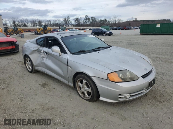 2003 Hyundai Tiburon GT z VIN KMHHN65F63U064962, wystawiony jako Copart lot #44804045 z przebiegiem 186 171 mil mil oraz Szkoda całkowita • Salvage title. Historia ofert i sprzedaży dostępna na DreamBid. Obrazek 4.